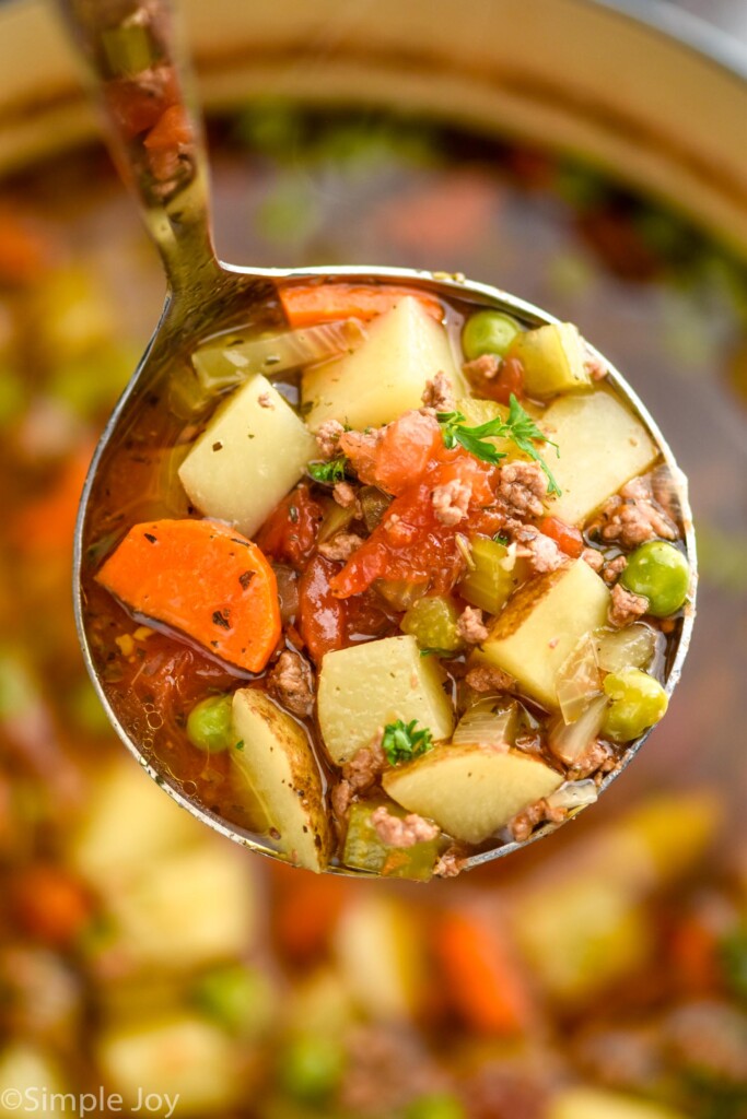 ladle of Vegetable Beef Soup over pot of Vegetable Beef Soup