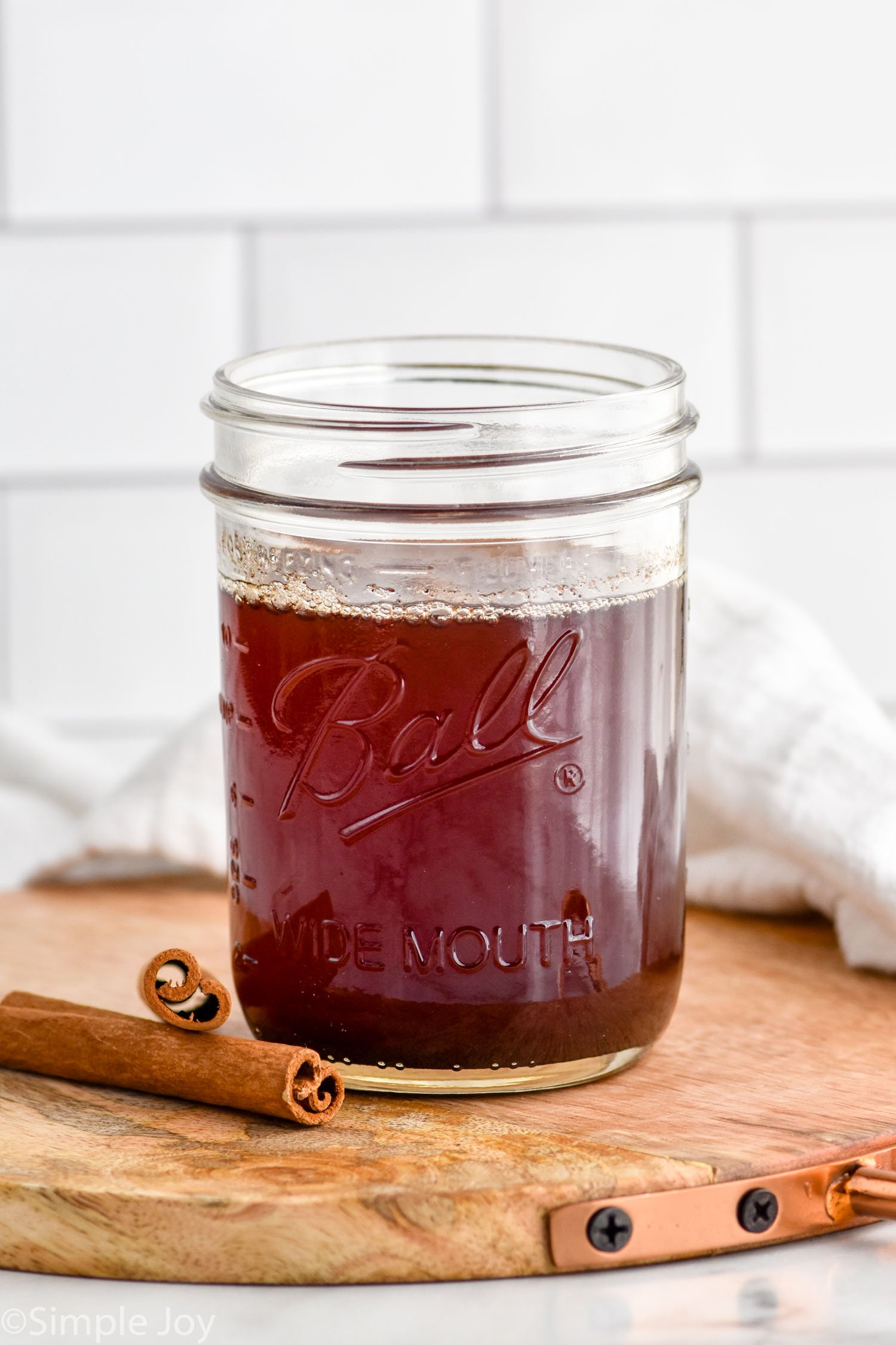 a small mason jar full of cinnamon syrup