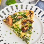 a piece of crustless spinach quiche on a white plate