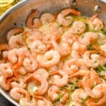 skillet of Garlic butter shrimp with sauce and fresh parsley