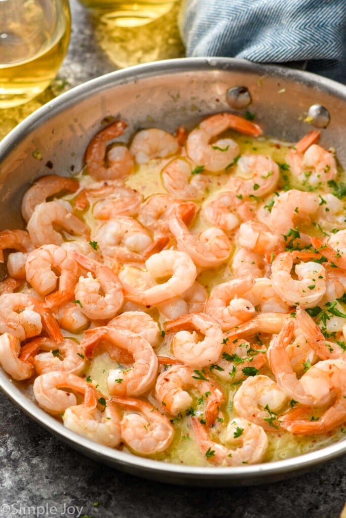 skillet of Garlic butter shrimp with sauce and fresh parsley