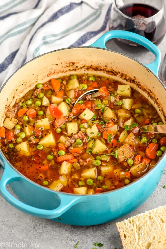 Large soup pot of Vegetable Beef Soup with a ladle