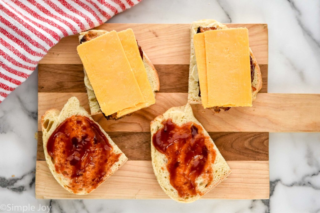 overhead of meatloaf sandwich ingredients on a wooden cutting board to show how to make a meatloaf sandwich