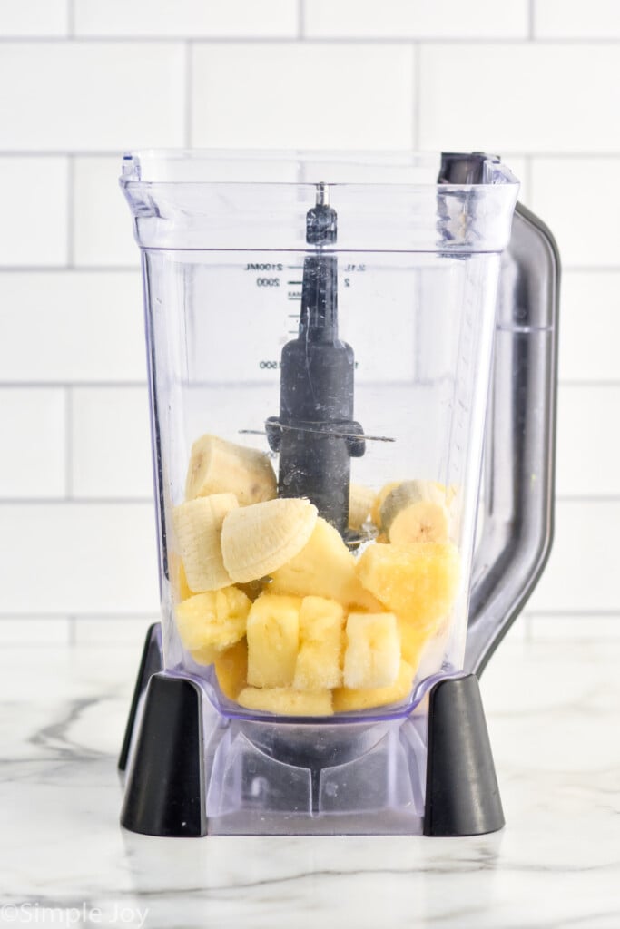 blender of frozen pineapple and banana pieces to make a Pineapple Smoothie