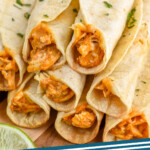 Pinterest graphic for Chicken Taquitos recipe. Image shows Chicken Taquitos stacked on top of each other. Text says, "Chicken Taquitos simplejoy.com."