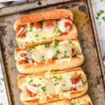 Pinterest graphic for meatball sub recipe. Text says, "the best meatball sub simplejoy.com." Image shows overhead view of meatball sub sandwiches on a baking sheet.