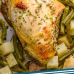 pinterest graphic of close up of a cooked cooked sheet pan chicken with potatoes and green beans around it, says: sheet pan chicken simplejoy.com