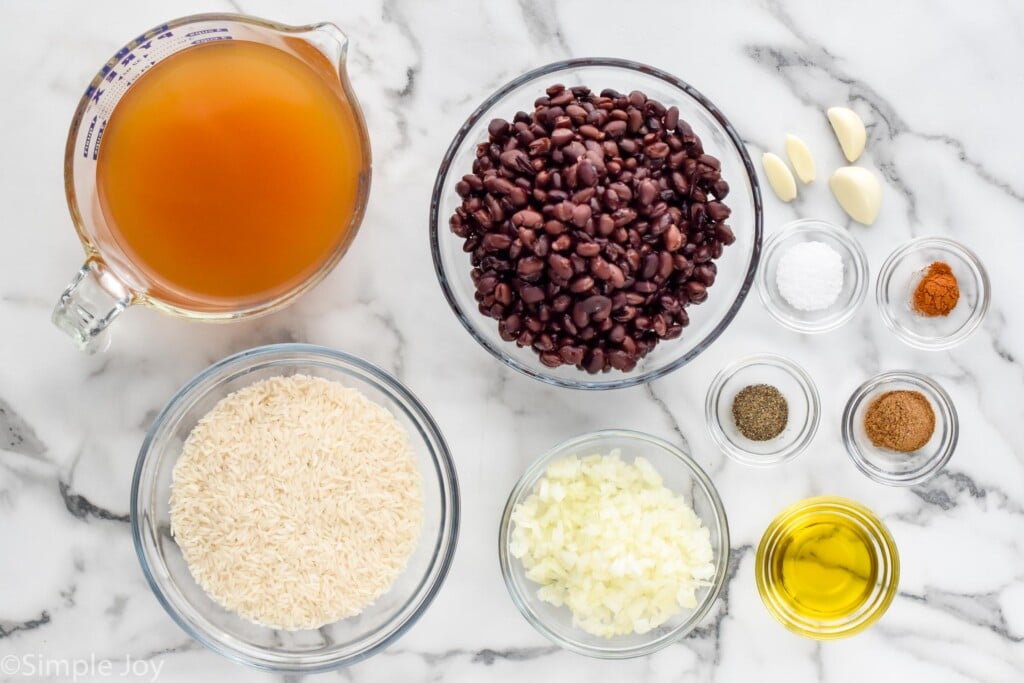 Overhead view of ingredients in separate bowls on counter for Black Beans and Rice recipe.