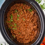 Overhead view of Slow Cooker Taco Meat in a crock pot garnished with cilantro