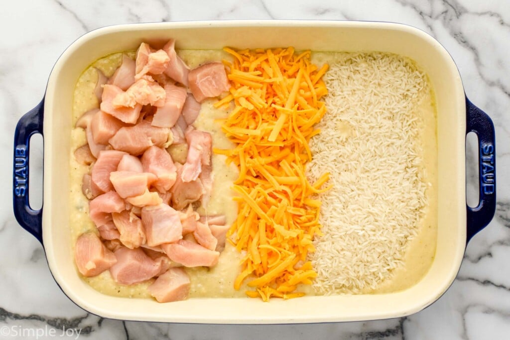 Overhead view of a baking dish of ingredients for Chicken and Rice Casserole recipe