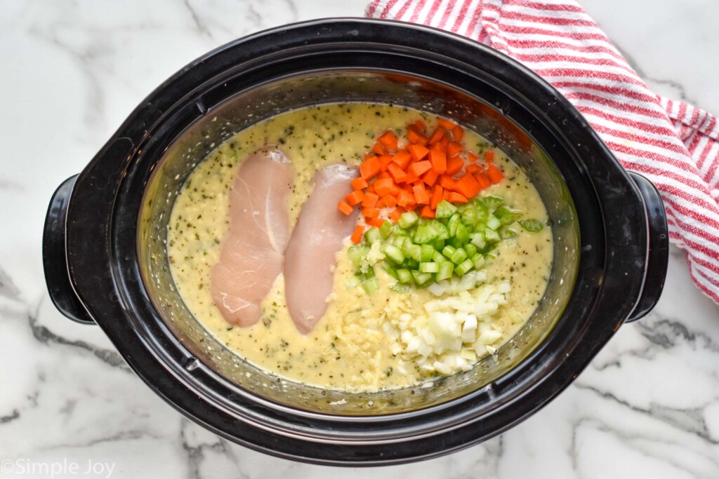 Overhead view of crock pot of ingredients for Crockpot Chicken and Dumplings recipe