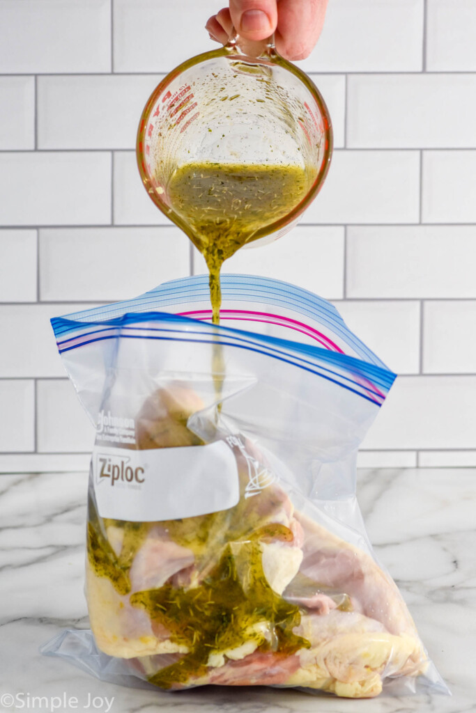 pouring marinade over chicken breasts in a ziplock bag