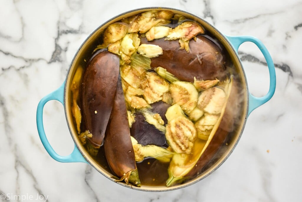 overhead of stockpot of eggplant in water to make Stuffed Eggplant