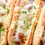 Close up photo of meatball sub sandwiches on a baking sheet