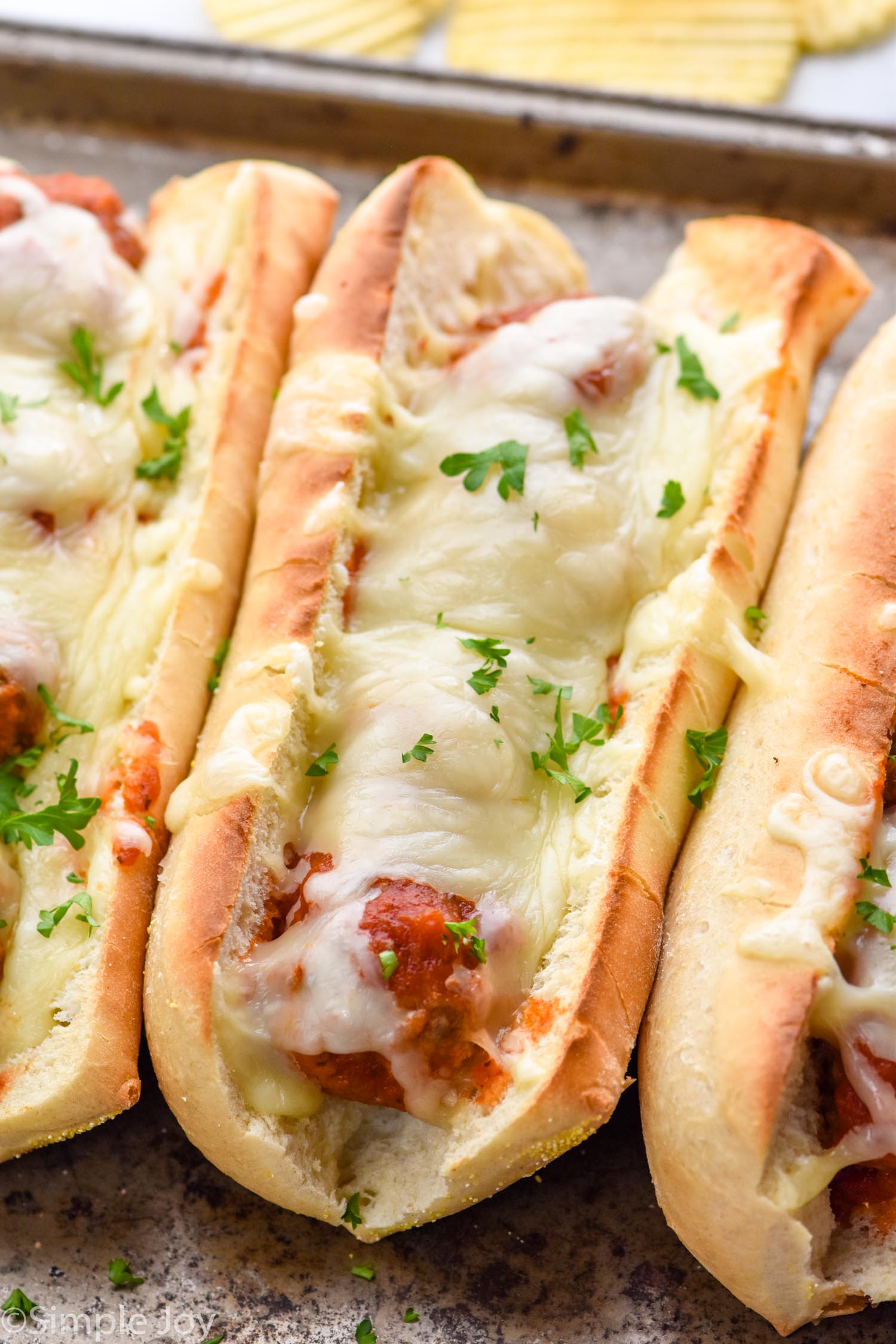 Close up photo of meatball sub sandwiches on a baking sheet