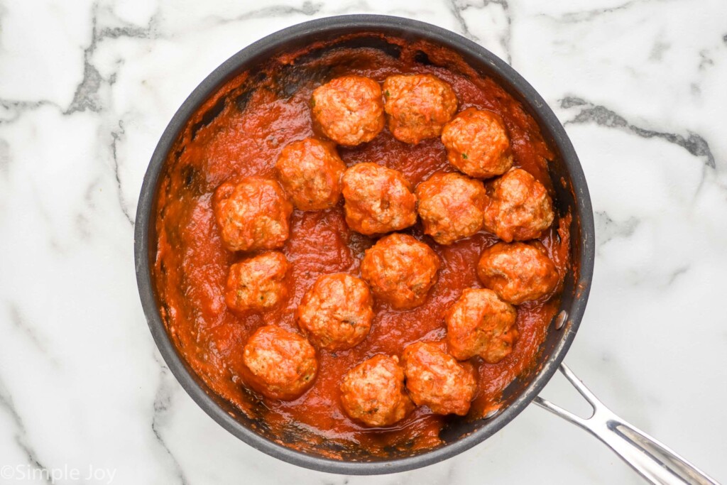 Overhead view of a pan of meatballs in sauce for meatball sub recipe