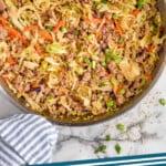 Pinterest graphic for Egg Roll in a Bowl recipe. Overhead view of a skillet of Egg Roll in a Bowl with chop sticks beside. Text says, "eggroll in a bowl simplejoy.com."