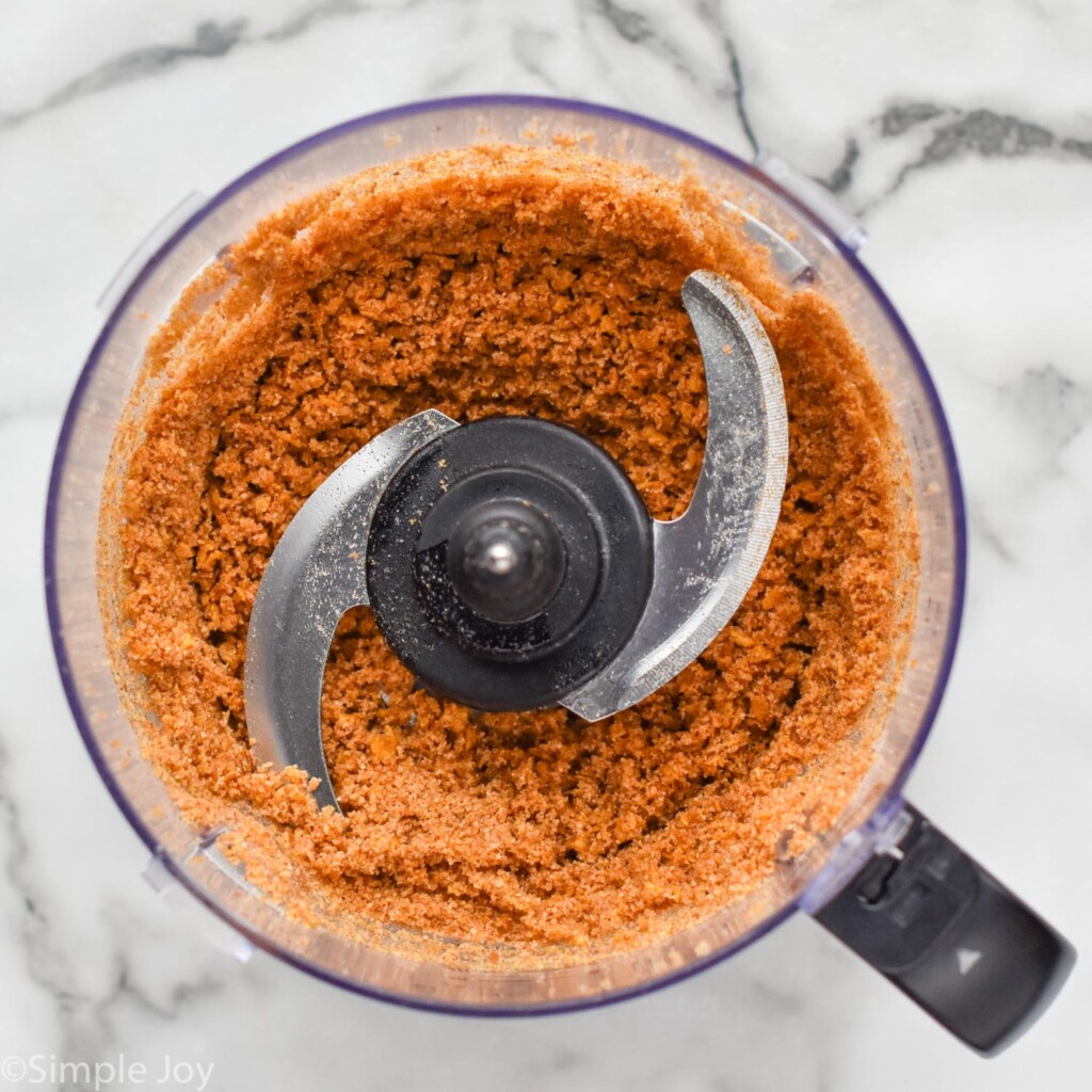 overhead of food processor with Baked Chicken Tenders breading ingredients