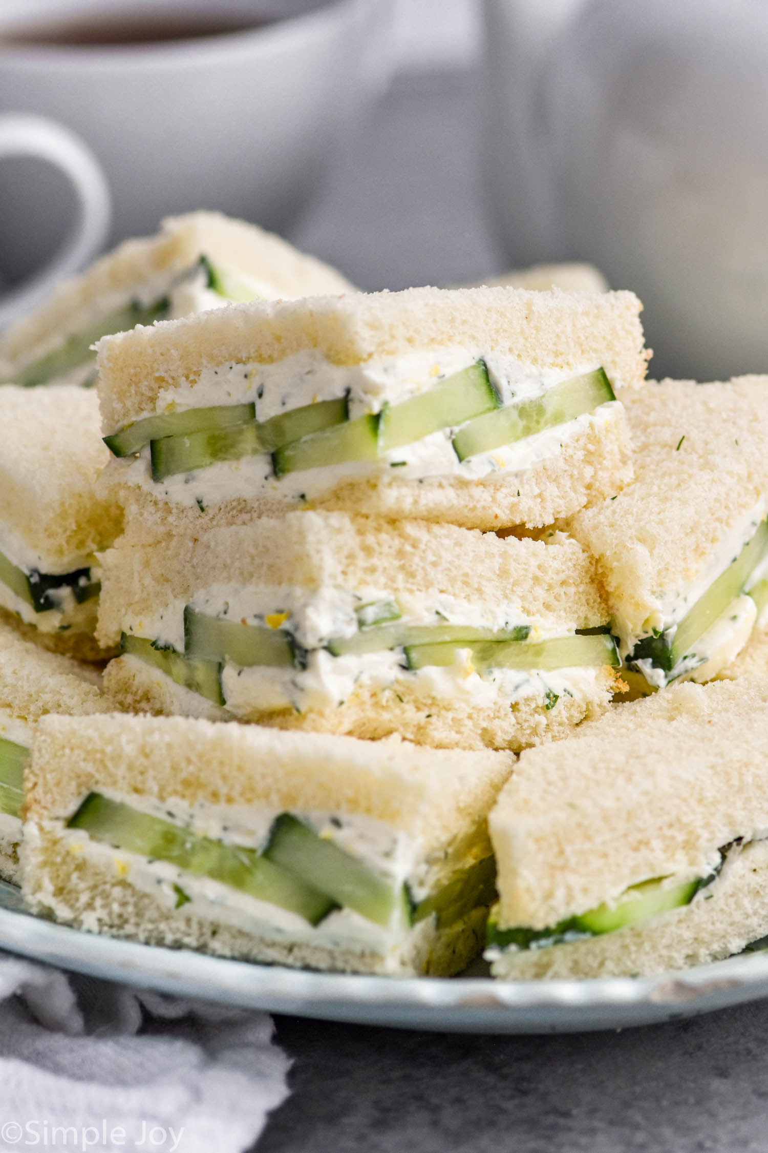 plate of cut cucumber sandwiches