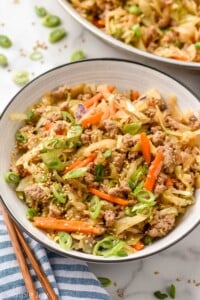 Bowl of Egg Roll in a Bowl with chop sticks beside.