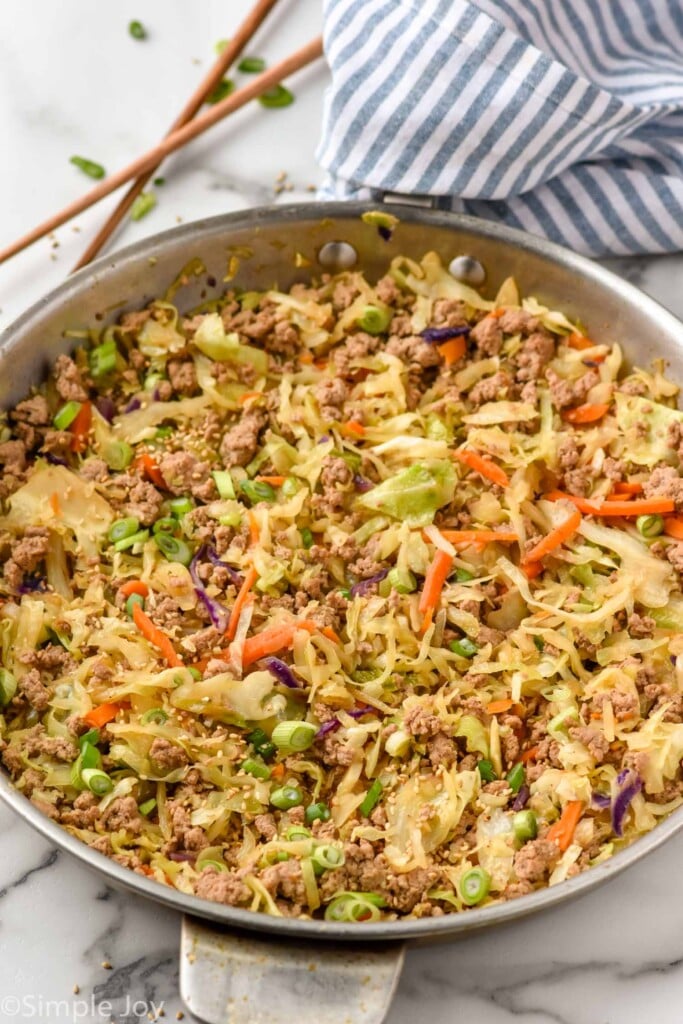 Skillet of Egg Roll in a Bowl with chop sticks beside.