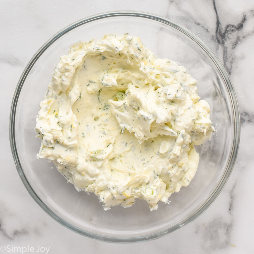 overhead of bowl of cream cheese filling mixture to make cucumber sandwich