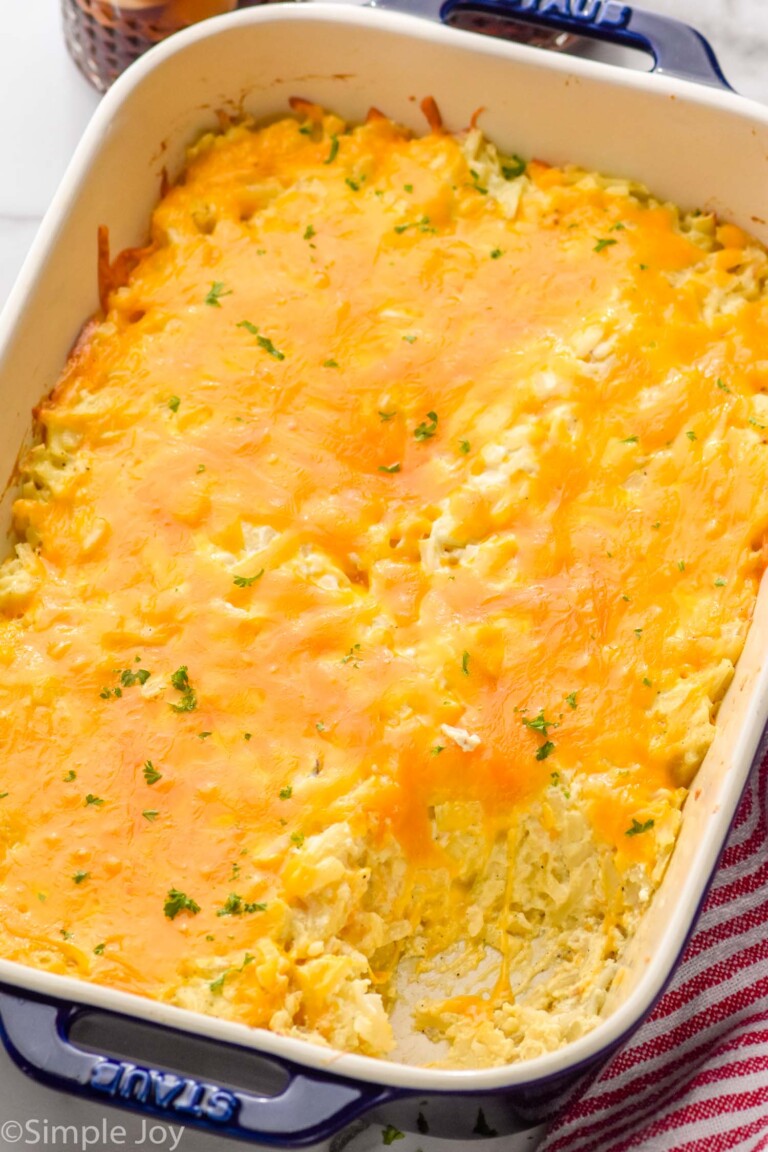 Overhead view of a baking dish of hashbrown casserole with one serving removed