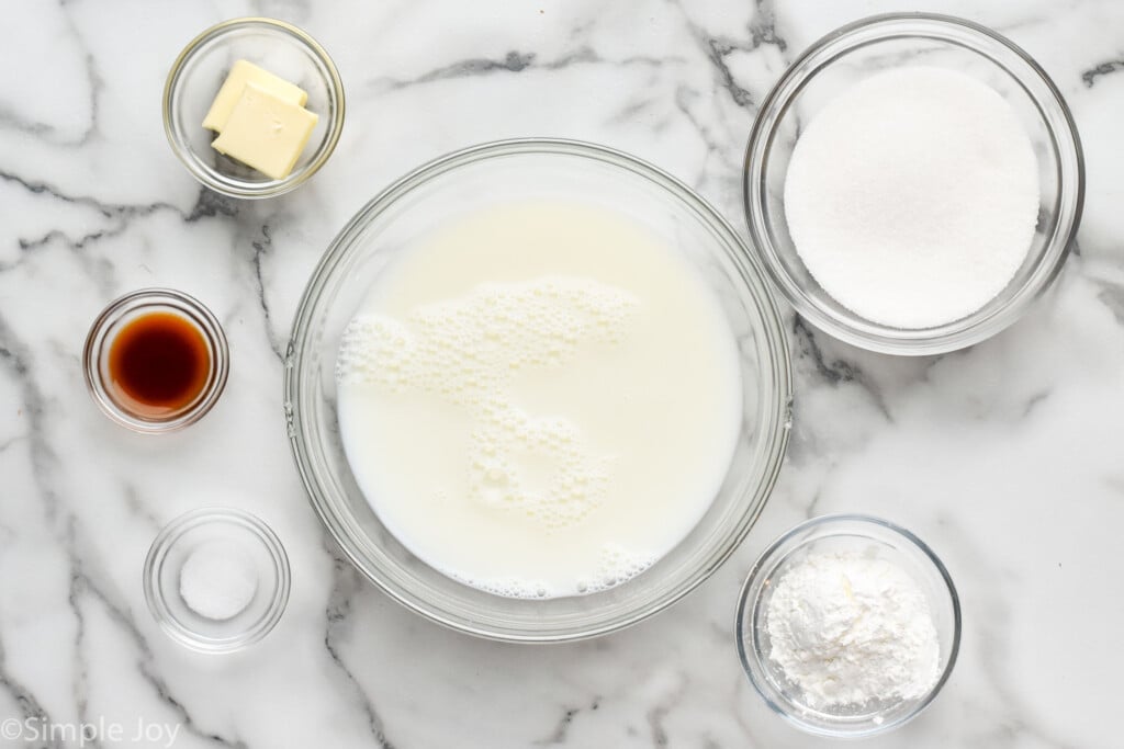 Overhead view of bowls of ingredients for Pudding recipe on countertop.